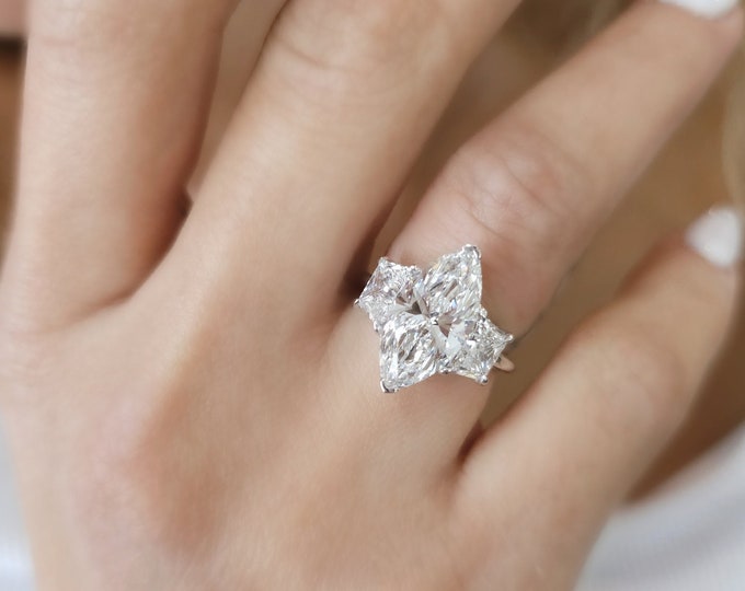 This Victorian style cathedral setting features a unique single prong 0.50 carats diamond halo and is set with a 3 carat center oval cut diamond