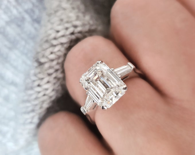 A timeless classic featuring a IGI certified 3.50 carat emerald cut CVD lab grown diamond complemented by two perfectly matched tapered baguette diamonds