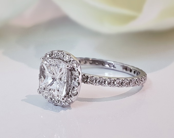This unique pave diamond & halo setting features a 2 Carat Cushion Cut IGI Certified CVD lab grown diamond & 0.75 carats accent diamonds