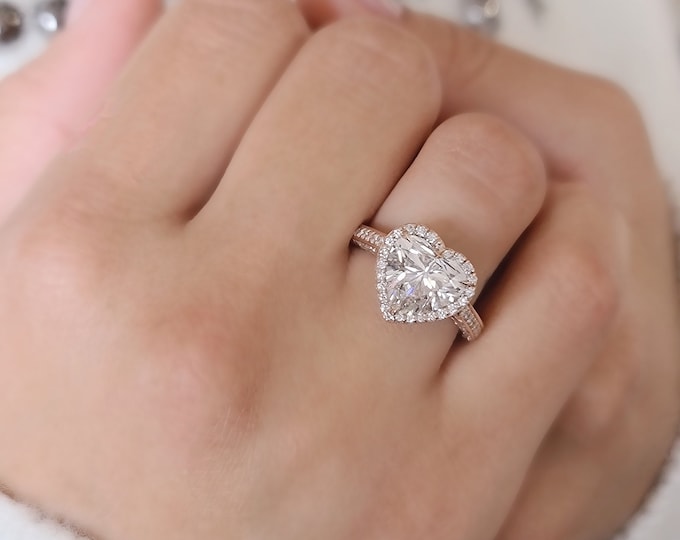 This Unique Heart Shape Halo Diamond Ring features a 3 carat Heart Diamond and is accentuated by 1.03ct pave set diamonds
