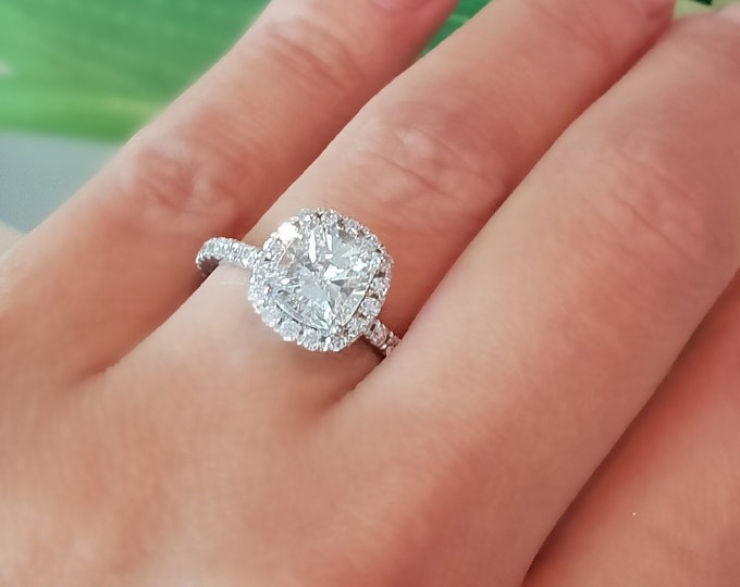 This unique pave diamond & halo setting features a 2 Carat Cushion Cut IGI Certified CVD lab grown diamond & 0.75 carats accent diamonds