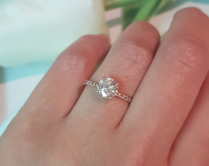 This classic 14K rose gold dainty pave diamond setting features a 1 carat Ideal Round brilliant cut IGI certified CVD lab grown diamond