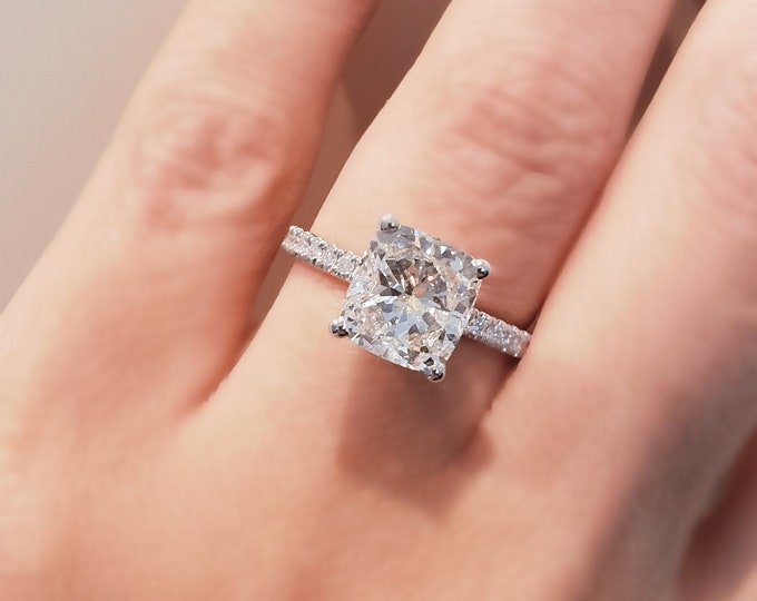 This classic diamond pave setting features a 2 carat IGI certified CVD lab grown cushion cut diamond & 0.34 carats accent diamonds