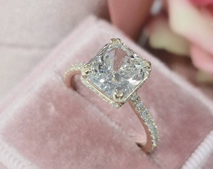 This 14K yellow gold pave diamond setting features an invisible gallery set with a 3 carat radiant cut IGI CVD lab grown diamond