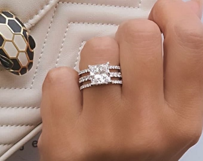 This unique three row diamond hidden halo setting features a 3 Carat IGI CVD lab grown Princess Cut diamond set in 14K white gold