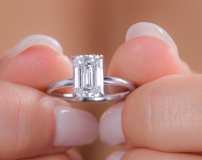This classic solitaire 14K white gold setting features a 2.50 carat IGI certified CVD lab grown emerald cut diamond