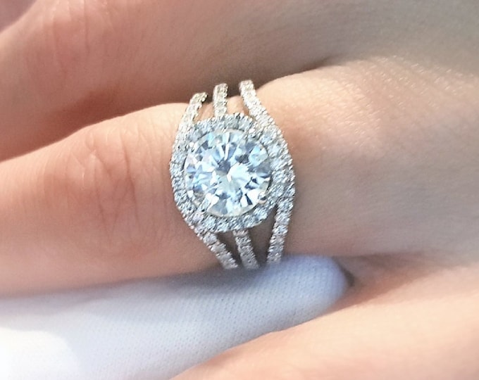 This unique 3 piece bridal ring set features a 2 carat center Ideal Round Brilliant cut IGI certified CVD lab grown diamond and is accomplished with2 matching flushing wedding bands