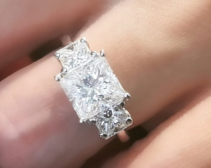 Classic 3 Stone Diamond Engagement Ring set with a 2 Carat Princess cut center diamond and 0.50ct side stones