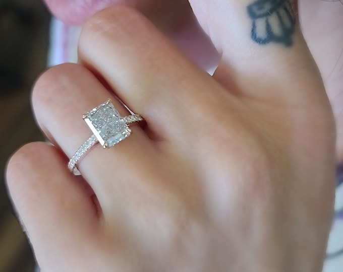 This elegant 14K Rose Gold diamond pave setting features a 2 carat CVD lab grown IGI Certified elongated Radiant cut diamond center stone