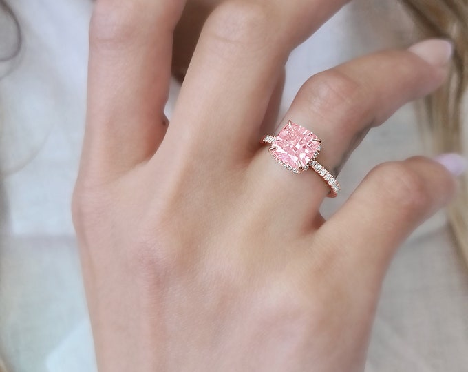 This classic rose gold hidden halo setting features a 3 carat IGI certified pink CVD lab grown cushion cut diamond & 0.47 carats accent diamonds