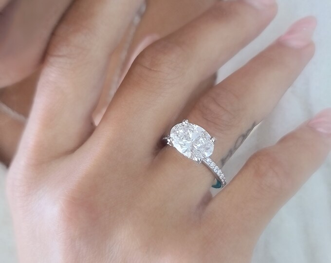 East West 3 Carat Oval Cut IGI Certified CVD Lab Grown Diamond set in a stunning hidden halo with diamond accents and diamond pave band setting