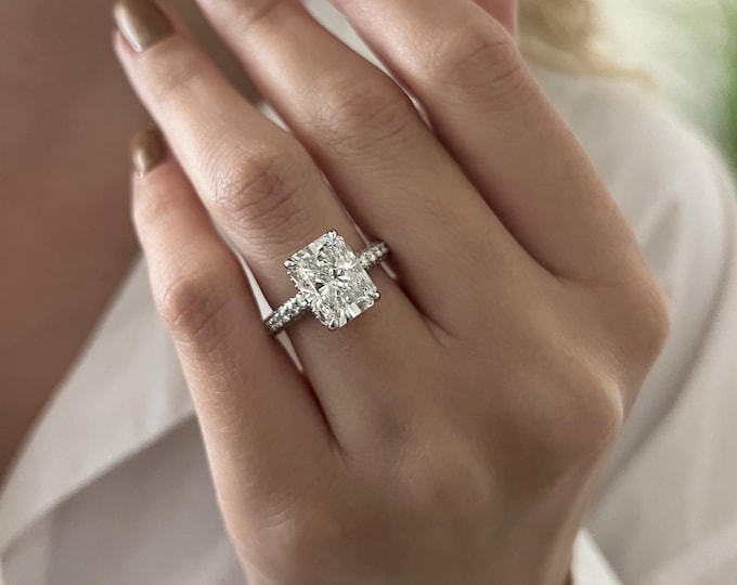 This gorgeous hidden halo setting features a 4 carat IGI Certified CVD lab grown elongated radiant cut set with 1.78ct accent diamonds