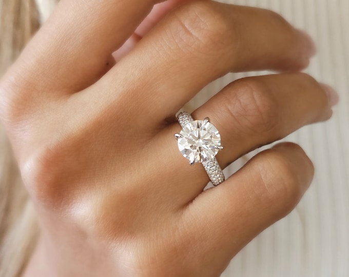 This classic 3 row diamond pave set solitaire ring features a 3 carat IGI certified Ideal round brilliant cut CVD lab grown diamond accentuated with 0.55 carats small diamonds
