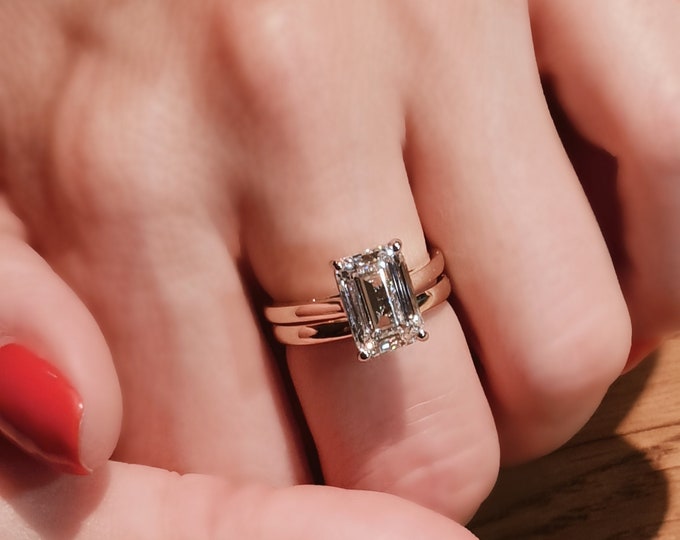 This classic 2 tone 18K gold cathedral setting features a 3.50 carat emerald cut IGI certified CVD lab grown diamond