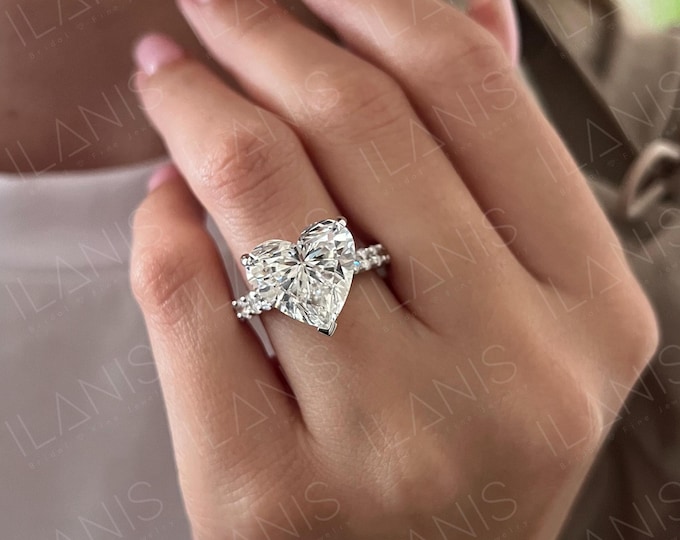 This Unique Rose Gold  Setting features a 9 Carat Heart Shaped IGI Certified CVD lab grown diamond accentuated with 0.64 carats side stones