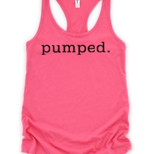 May include: A pink racerback tank top with the word "pumped." printed in black on the front.
