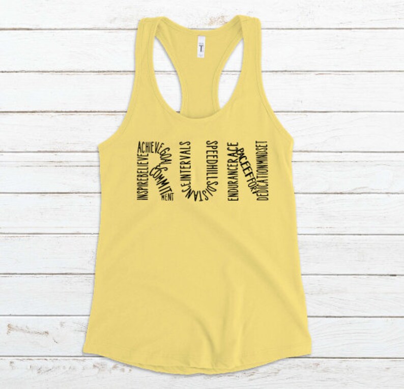 May include: Yellow tank top with the word "RUN" spelled out in black text. The letters are made up of words related to running, such as "achieve", "inspire", "believe", "speed", "hills", and "race".