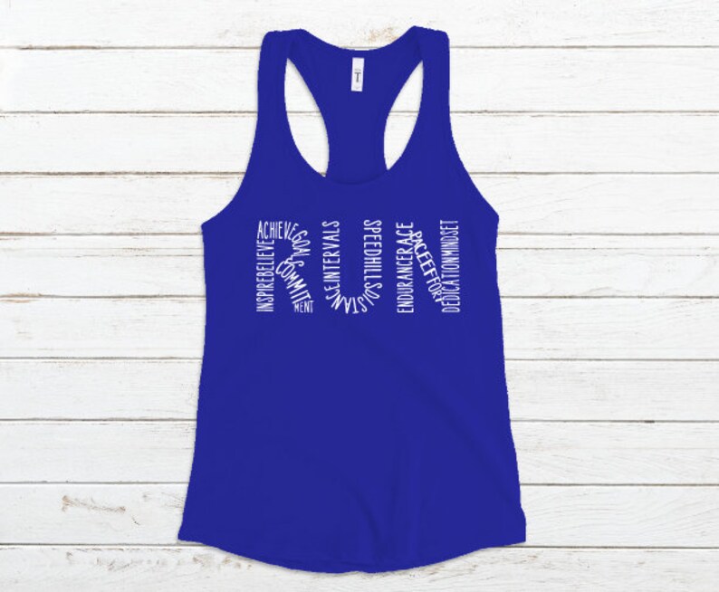 May include: A royal blue tank top with white text that reads "RUN" in a circle. The text inside the circle reads "Achieve, Inspire, Believe, Commit, Goals, Ment, Speed, Hill, Intervals, Sustain, Strength, Endurance, Race, Effort, Dedication, Mindset".