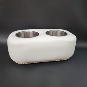 May include: White padded cup holder with two stainless steel cup inserts.