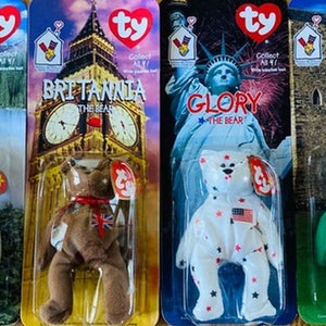 May include: Four Ty Beanie Baby plush toys in their original packaging. The toys are Maple the Bear, Britannia the Bear, Glory the Bear, and Erin the Bear. Each toy is wearing a different outfit representing a different country. Maple is wearing a white outfit with a Canadian flag, Britannia is wearing a brown outfit with a Union Jack, Glory is wearing a white outfit with a US flag, and Erin is wearing a green outfit with a shamrock.