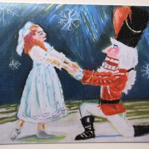 May include: An oil painting of a scene from The Nutcracker ballet. A ballerina in a light blue dress and a Nutcracker in a red coat and black hat are holding hands. The background is dark blue with white snowflakes.