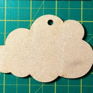 May include: A plain, light brown wooden cloud-shaped ornament with a hole at the top for hanging.