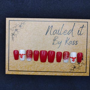 Red gel press on nails with white accent nail and glitter ombre nail in any size or shape.