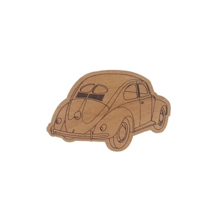 May include: A brown paper cutout of a vintage Volkswagen Beetle car.
