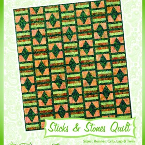 May include: A quilt pattern named "Sticks & Stones Quilt" with a geometric design in green, orange, and brown. The pattern features diamond and rectangular shapes. The text "Fun & Done! Quilting" is at the top, with "Fairy Lake Quilt Designs" at the bottom.