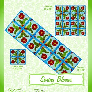 May include: A quilting pattern titled "Spring Blooms" with a floral design of red flowers, green leaves, and blue accents. Includes patterns for a 76 x 76 cm topper, a 38 x 38 cm table mat, and a 38 x 114 cm runner. The text "Fun & Done! Quilting" is at the top.