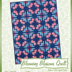 May include: A quilt pattern design titled "Blooming Blossoms Quilt" by Fairy Lake Quilt Designs. The quilt features a repeating pattern of pink and blue arrows on a dark blue background. The pattern is available in crib, lap, and twin sizes.