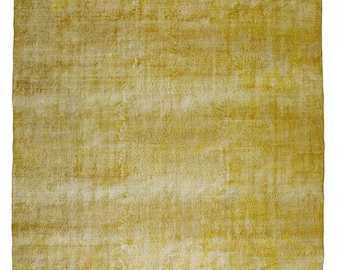 May include: A solid yellow rug with a subtle, faded pattern. The rug has a soft, worn look and a slightly textured surface.