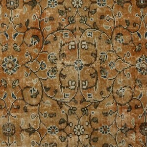May include: A vintage rug with a detailed floral pattern in shades of brown, beige, and blue. The rug has a worn, distressed look, giving it a unique character.