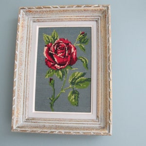Red rose canvas tapestry on a gray background with its original frame, gift from the 60s
