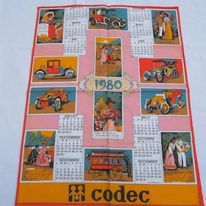 May include: A pink and orange 1980 calendar tea towel with a vintage car theme. Each month features a different car and a couple in period clothing. The text "1980" is in a large, decorative font. The bottom of the towel has the word "codec" in a large, bold font.