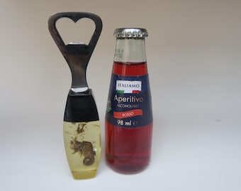 Bottle opener with seahorse inclusion