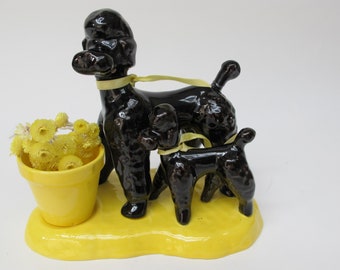 Set of two black poodles with small pot and yellow stand