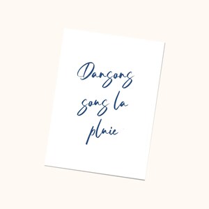 May include: A white card with the text 'Dance song la pluie' written in blue cursive script.