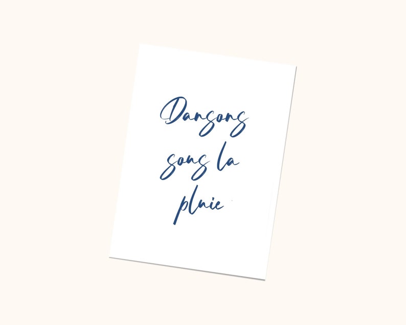 May include: A white card with the text 'Dance song la pluie' written in blue cursive script.