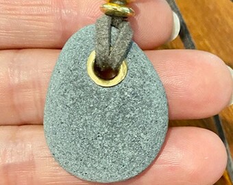 Riveted beach pebble pendant