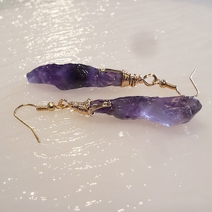 Los aretes de amatista uruguaya son piedras preciosas raras de color violeta intenso. Cada juego de aretes es una pieza única hecha a mano.