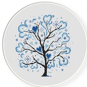 May include: A blue and white cross-stitch pattern of a stylized tree with hearts and snowflakes. The tree is on a white background.