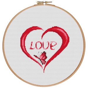 May include: A red heart with a butterfly and the word "LOVE" in a white embroidery hoop.