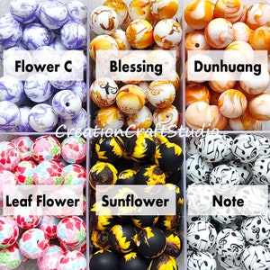 May include: Six containers of colourful silicone beads with different patterns. The containers are labelled "Flower C", "Blessing", "Dunhuang", "Leaf Flower", "Sunflower", and "Note".
