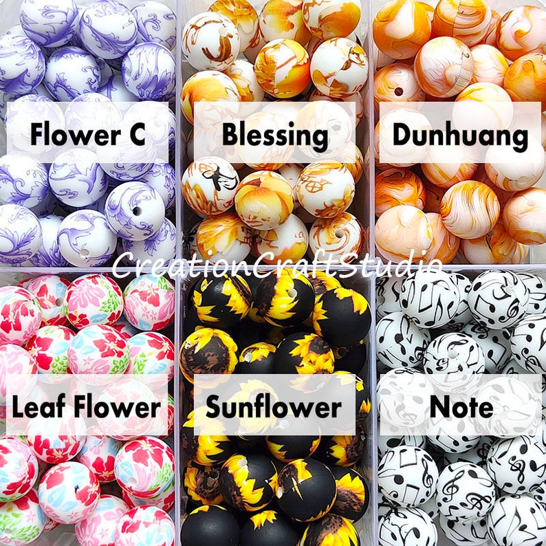 May include: Six containers of colourful silicone beads with different patterns. The containers are labelled "Flower C", "Blessing", "Dunhuang", "Leaf Flower", "Sunflower", and "Note".