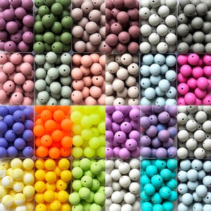 May include: A selection of colourful silicone beads in a grid arrangement. Shades include pink, green, orange, yellow, purple, blue, and white. Each bead is round with a hole for threading. Suitable for crafts and jewellery making.