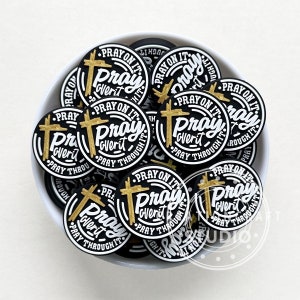 May include: A bowl filled with black and gold round stickers that say "Pray On It, Pray Over It, Pray Through It".