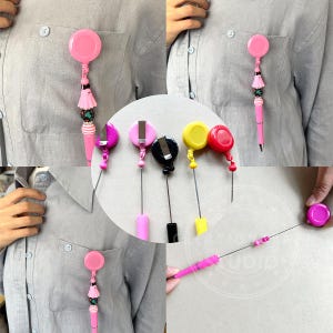 May include: A set of retractable badge holders with different colored clips and retractable cords. The clips are black, pink, yellow, and red. The cords are all black. The badge holders are shown on a white background.