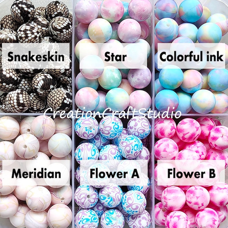 May include: Six containers of colourful silicone beads for jewellery making. The beads are in different patterns, including snakeskin, star, colourful ink, meridian, flower A, and flower B.