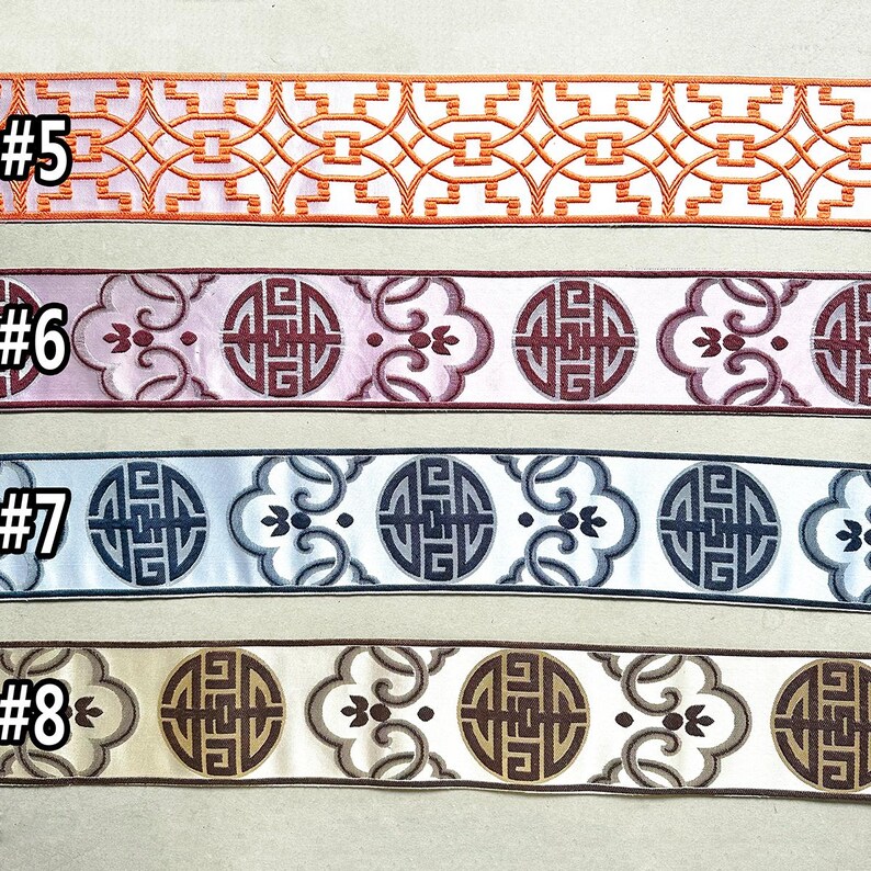 May include: Four samples of decorative trim with different colors and patterns. The trim features a repeating design of a circle with a geometric pattern inside, surrounded by floral motifs. The trim is labeled #5, #6, #7, and #8.